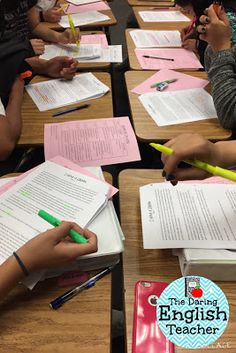 several people sitting at desks with papers and pencils in front of their faces