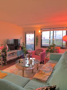 a living room filled with lots of furniture and a flat screen tv mounted to the wall