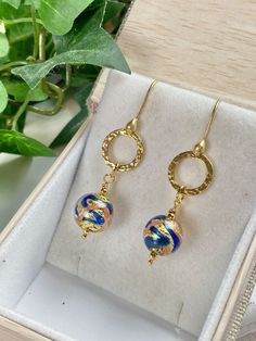 "Elegant and classic Murano glass earrings will be a great addition to your jewelry wardrobe! These genuine Murano glass beads are sourced directly from the artisans in Murano, Italy & Venice. These glass beads are miniature works of art as these artisans employ ancient techniques to achieve the amazing clarity of the glass and colors. The blue color is dazzling! 14k gold foil is within the beads with swirls of Aventurine! High quality meets high art for a truly special piece of jewelry! The gla Elegant Round Glass Earrings, Elegant Hypoallergenic Glass Jewelry, Elegant Round Murano Glass Jewelry, Elegant Hypoallergenic Glass Earrings, Elegant Czech Glass Pierced Earrings, Elegant Glass Dangle Earrings, Elegant Nickel Free Glass Earrings, Elegant Nickel-free Glass Earrings, Elegant Pierced Earrings With Czech Glass