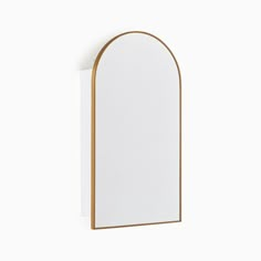 an arch shaped mirror mounted on the wall with a wooden frame and gold trimming