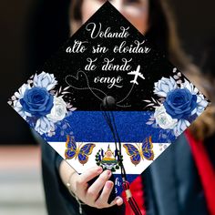 a graduate holds her cap decorated with flowers