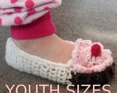 someone is wearing crocheted slippers with a heart on the top and bottom