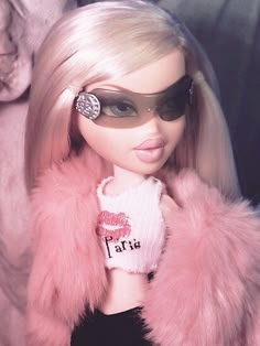 a barbie doll wearing sunglasses and a pink fur coat