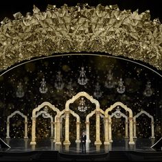 the stage is decorated with gold and white decorations