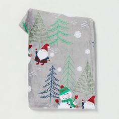 a christmas themed towel with santa claus and snowmen in the woods on grey background