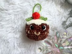 a crocheted christmas ornament with a hat on it's head