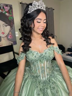 a woman in a green dress with a tiara