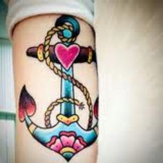 an anchor and heart tattoo on the leg