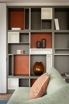 a living room filled with lots of bookshelves next to a couch and coffee table