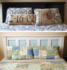 a bed with two pillows on top of it and the bottom one has a pillow that says, 2 - 16 - 02