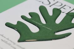 an open book with green paper cut out of it