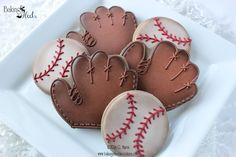 decorated cookies in the shape of baseballs on a plate