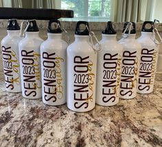 six white water bottles sitting on top of a counter