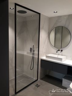 a bathroom with a walk in shower next to a sink