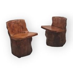 two wooden chairs made to look like logs