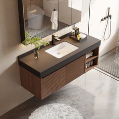 a bathroom with a sink, mirror and shower stall in it's own area