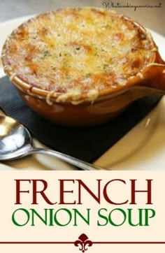 the cover of french onion soup on a plate with spoons