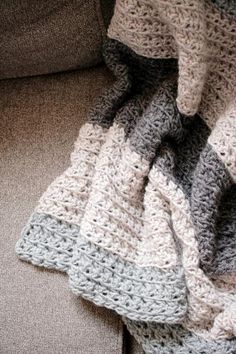 a crocheted blanket sitting on top of a couch