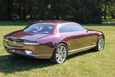 a car parked in the grass near some trees