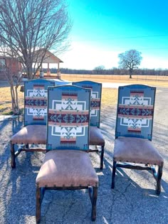 four chairs sitting in the middle of a parking lot