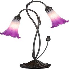 a lamp that is on top of a metal stand with two flowers in the middle