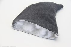 a close up of a gray hat on a white surface