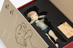 a figurine in a box with a drawing on it