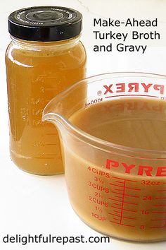 a measuring cup filled with liquid next to a jar of turkey broth