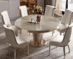 a round table with white chairs around it