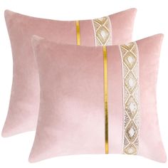 two pink velvet pillows with gold trims