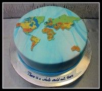 there is a blue cake with a map on the top that says there is a whole world out there