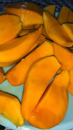 sliced mangoes on a blue plate ready to be eaten