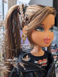 a close up of a doll with long hair and braids on it's head