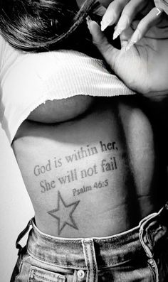 a woman with her back tattoo saying god is within her, she will not fail