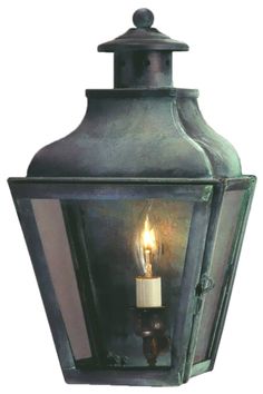 an outdoor light with a candle on it