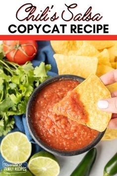 a person dipping tortilla chips into a bowl with salsa