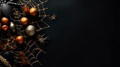 an arrangement of halloween decorations on a black background with spider webs and pumpkins