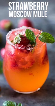 strawberry moscow mule in a glass with mint garnish on the rim and text overlay