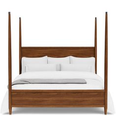 a bed with four posts and white sheets