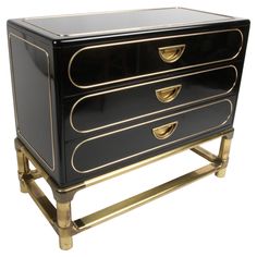 a black and gold dresser with three drawers