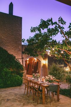 an outdoor dining area with table and chairs