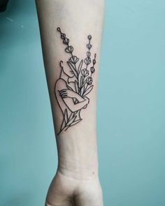 a woman's arm with a flower tattoo on the left side of her body