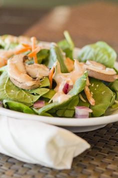 a salad with mushrooms and lettuce on a plate