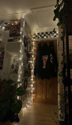 a room with some lights on the wall and clothes hanging up in front of it