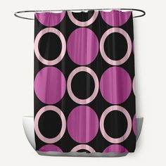 a black and pink shower curtain with circles on it