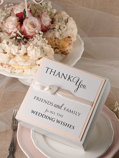 a wedding cake and thank you card on plates