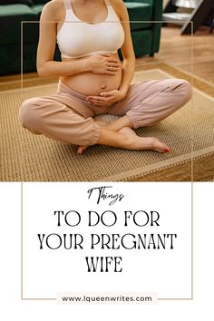 a pregnant woman is sitting on the floor with her stomach exposed and holding her belly