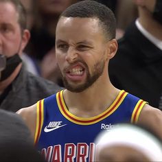 a basketball player with his mouth open in front of the crowd