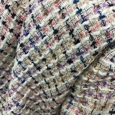 close up view of the back of a tweed jacket with multicolored patterns on it