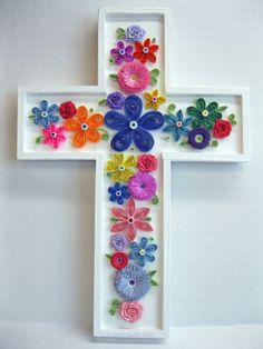 a white cross with colorful flowers on it